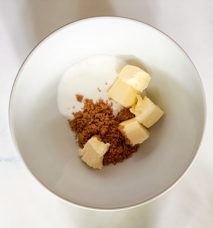 soft butter and brown sugar and white sugar in a bowl