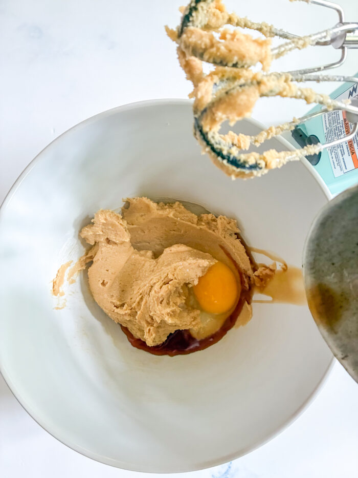 adding wet ingredients to creamed butter and sugar