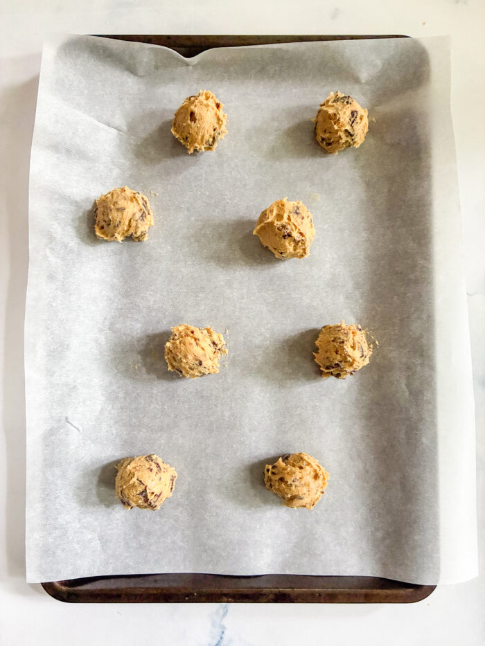 small mounds of cookie dough on a sheet pan ready to bake