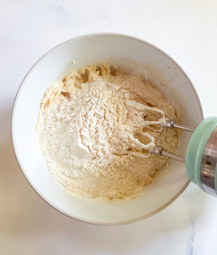 adding dry ingredients to cookie dough