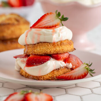 Individual classic strawberry shortcake on a plate with whipped cream