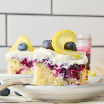 a slice of blueberry lemon poke cake on a plate