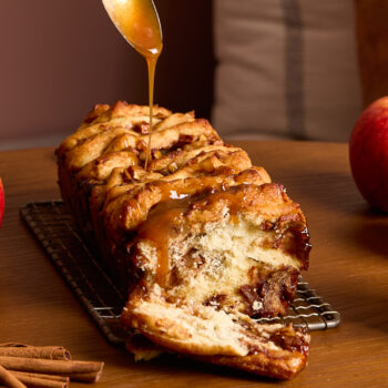 Apple Cinnamon Pull Apart Bread being drizzled with caramel sauce