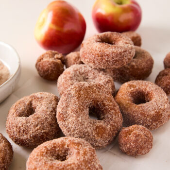 apple cider donuts and holes on a countertop all spread out