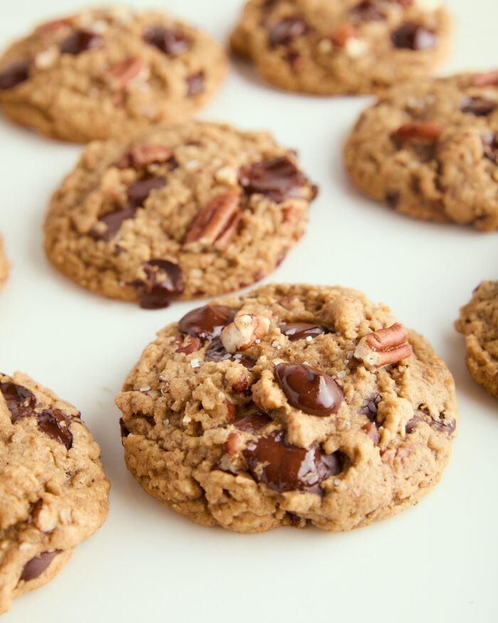 This is arguably the best ultimate chocolate chip cookies ever! The cookies are thick, and slightly crisp on the outside and incredibly chewy on the inside and made with brown butter and a good hit of flaky salt! brown butter chocolate chip cookies spread out on the counter
