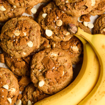 banoffee cookies in a pile with fresh bananas