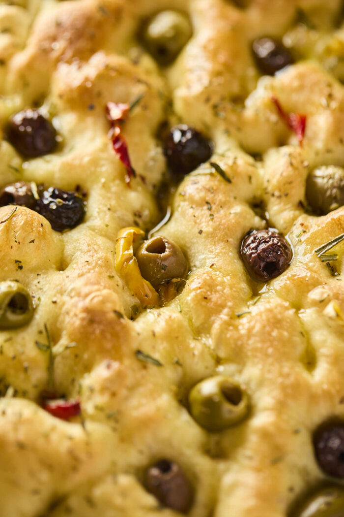 baked focaccia topped with olives and peppers