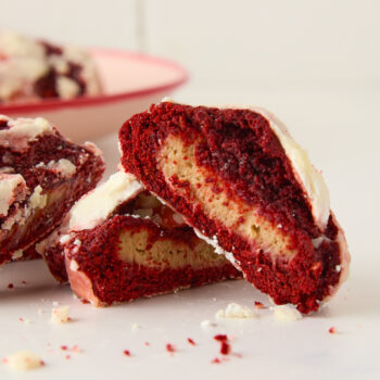 red velvet cookies cut in half to show the cream cheese filling